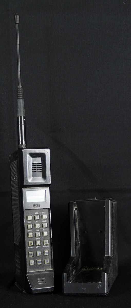 Handheld phone from late 1980s with charging cradle